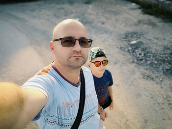 Portrait of man wearing sunglasses standing outdoors