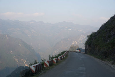 Road amidst mountains against sky