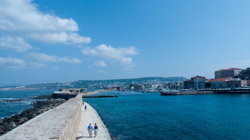 Panoramic view of sea and buildings against sky