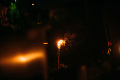 Close-up of lit candles in the dark