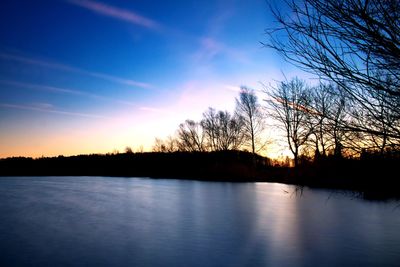 Scenic view of lake against sky during sunset