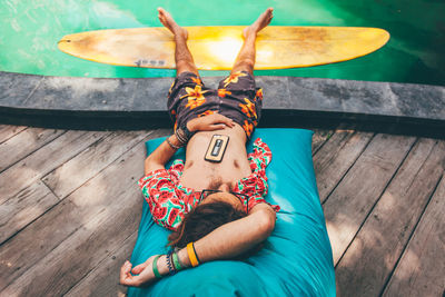 Man relaxing at poolside 