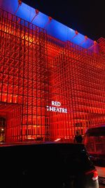 Low angle view of illuminated building against sky at night