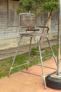 High angle view of empty chairs in yard against building