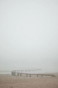 Pier over sea against clear sky