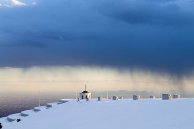 Snow covered landscape against sky