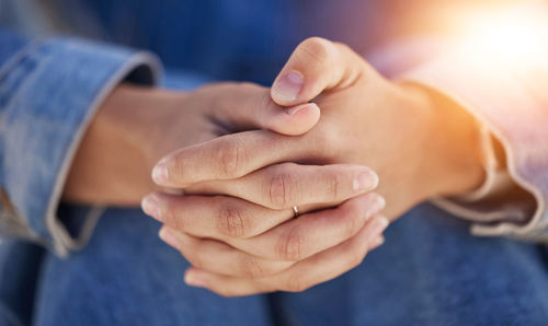 Midsection of couple holding hands