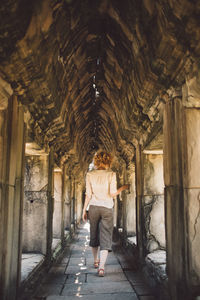 Woman standing in corridor of building