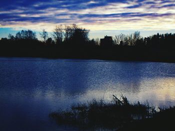 Scenic view of lake against sky at sunset