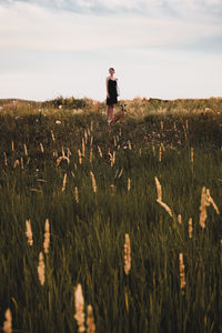 Man standing on field against sky