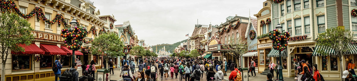 People walking on street amidst buildings in city