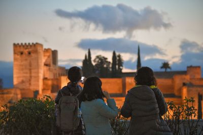 Rear view of girls against castle