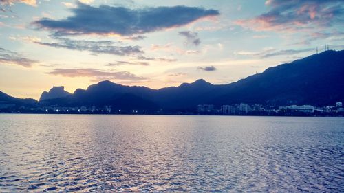 View of city at waterfront during sunset