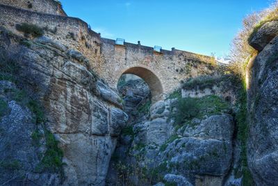 Low angle view of arch bridge against sky