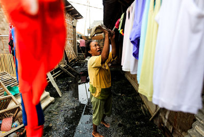 Side view of people standing on clothesline