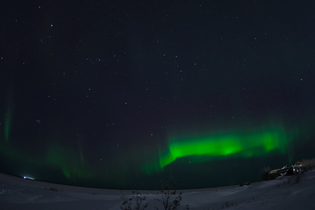 SCENIC VIEW OF SNOWCAPPED FIELD AGAINST SKY AT NIGHT