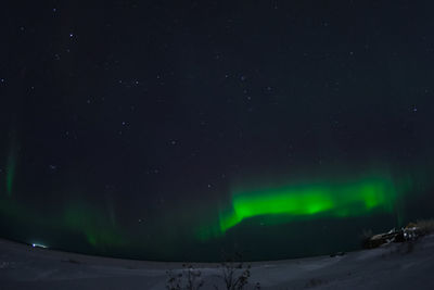 Scenic view of snow against sky at night