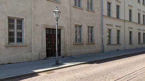 Street light by building in city