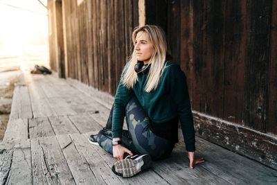 Full length of woman sitting outdoors