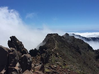 Scenic view of mountain against blue sky