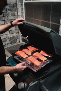 Cropped hand of man preparing food