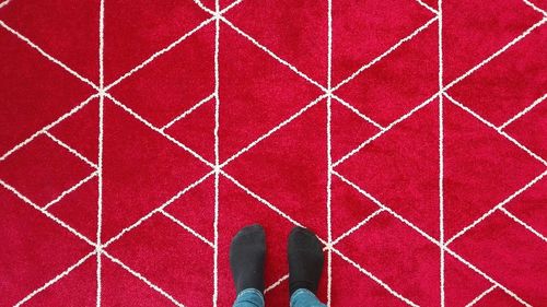Low section of person standing on tiled floor