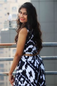 Portrait of a smiling young woman standing outdoors