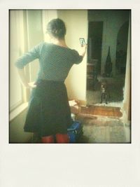 Full length of woman standing by railing