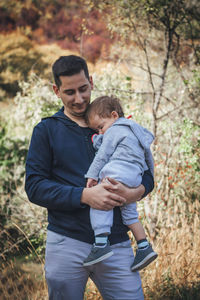Full length of father and daughter on tree
