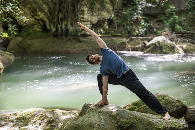 Full length of man jumping in lake