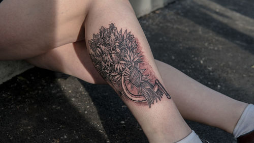 High angle view of woman hand with tattoo