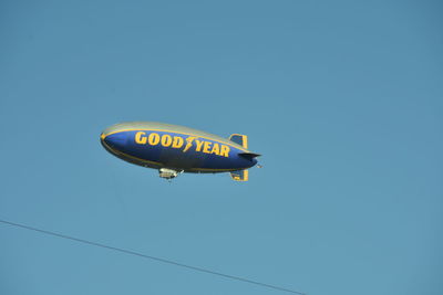 Low angle view of airplane flying against clear sky