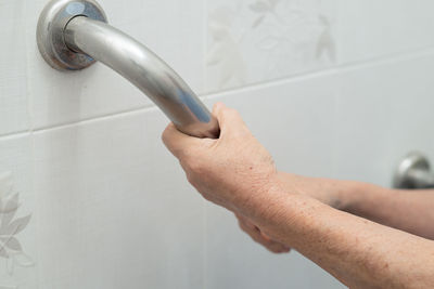 Close-up of hand holding faucet
