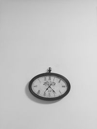 Close-up of clock over white background