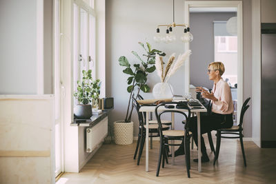 Woman sitting on chair at home