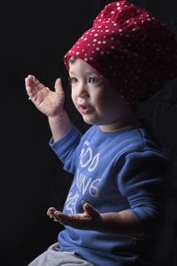 Cute girl with chef hat against black background