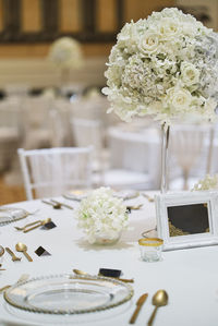 White roses in vase on table