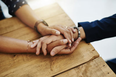 Cropped image of business people stacking hands