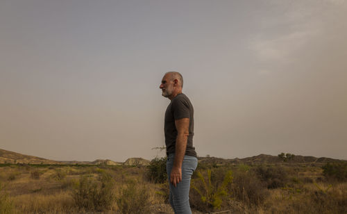 Adult man in tabernas desert, almeria, spain, in summer