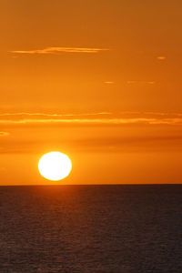 Scenic view of sea against romantic sky at sunset