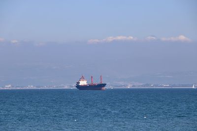 Boat sailing in sea against sky