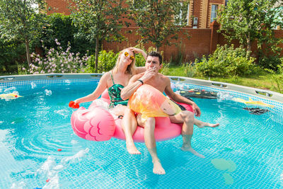 Full length of a young couple in swimming pool