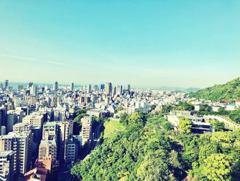 High angle view of buildings against clear blue sky