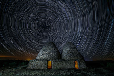 Sunlight falling on land against sky at night