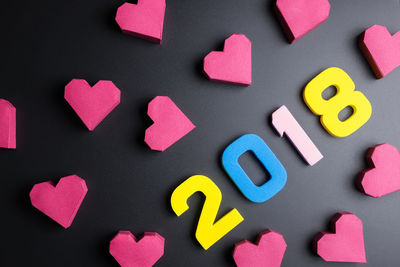 Close-up of multi colored heart shape and number 2018 on table