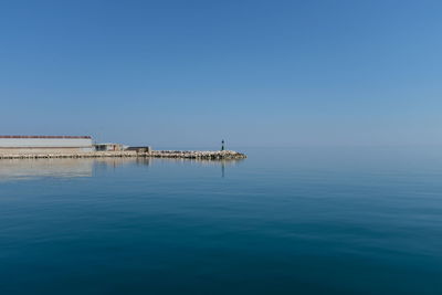 Scenic view of sea against clear blue sky