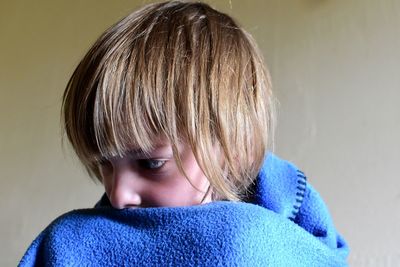 Close-up of boy wrapped in towel