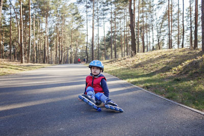 Boy riding motorcycle on road