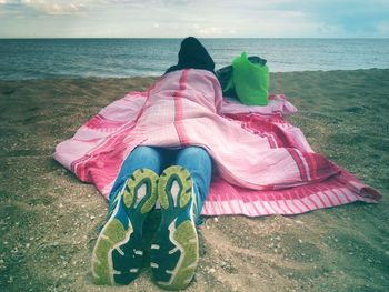 Midsection of multi colored umbrella on beach