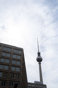 Low angle view of buildings against cloudy sky